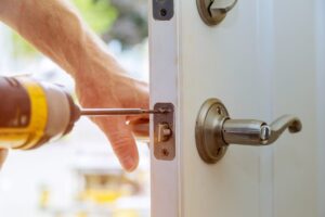 Residential locksmith repairing a home door lock